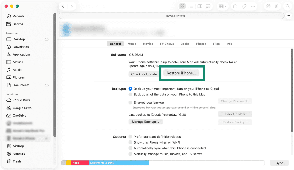 Windows' Apple Devices app interface, showing a connected iPhone and the Restore iPhone button in focus.